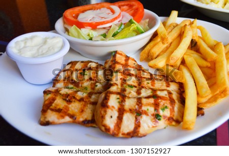 Delicious meal, Grilled chicken fillets with french fries and salad.  
