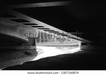 Black and white image of the lower metal part of the viaduct construction resembling 35 mm film perforation