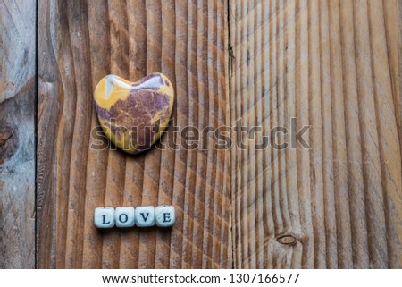 Love written in wooden letters and heart, valentines day background