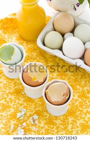 Soft boiled egg in egg cup and served with toast fingers.