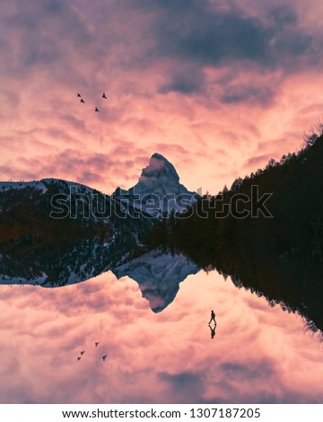 Person and Mountains in Fantasy Landscape at Sunset. Conceptual Alternate Reality Image.