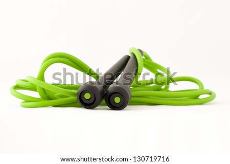 Green skipping rope for an exercise, isolated on white Royalty-Free Stock Photo #130719716