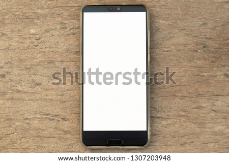 Smartphones on wooden background,Mobile smartphone iphon style mockup with white screen on wooden background. 