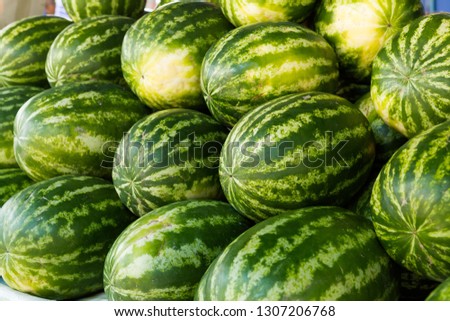 Ripe watermelons with a green striped 
rindbig.sweet green watermelons background 