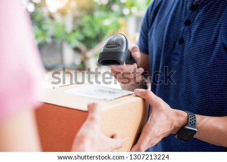 delivery service concept, customer hand receiving a cardboard boxes parcel from delivery man at home