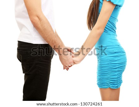 Young loving couple holding hands isolated on white