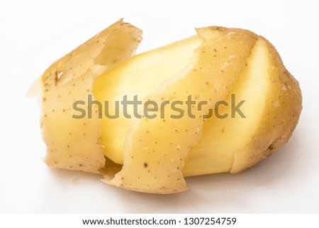 Peeled potato skin Royalty-Free Stock Photo #1307254759