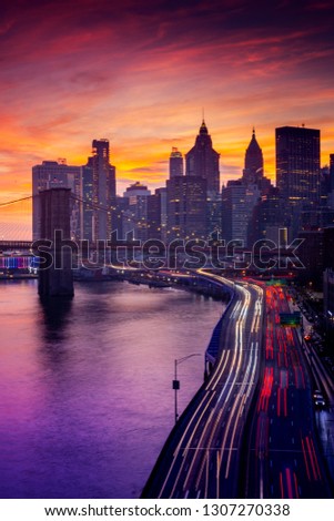 Must see when visiting New York City. View of Lower Manhattan and  Brooklyn at sunset. Night scene. Light trails. City lights. Urban living, travel, real estate  and transportation concept