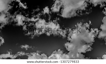 White clouds on a dark sky, monochrome.
