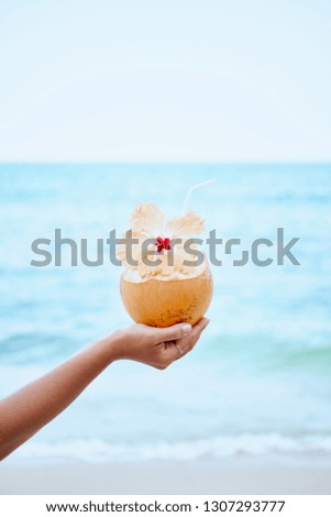 Fresh Exotic Coconut Water Drink in Woman Hand