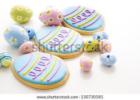 Easter cookies in shape of egg decorated with blue icing.