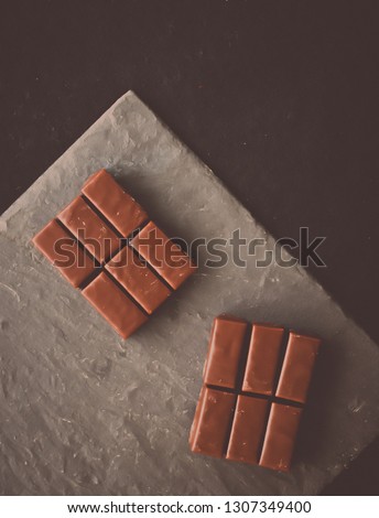 Sweet swiss chocolate candies on a stone tabletop, flatlay - desserts, confectionery and gluten-free organic food concept.  All you need is chocolate