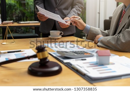 Concepts of law, Lawyer and businessman shaking hands in office after discussing contract and business papers. Royalty-Free Stock Photo #1307358835