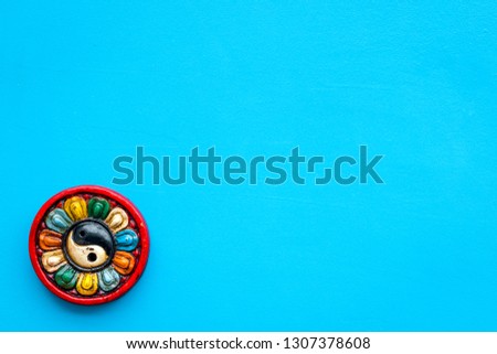 Buddhist symbol. Yin Yang symbol on blue background top view space for text