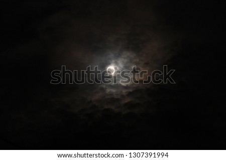 Total lunar eclipse in the cloudy sky