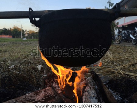 Black stainless steel pot and smoke on fire of charcoal