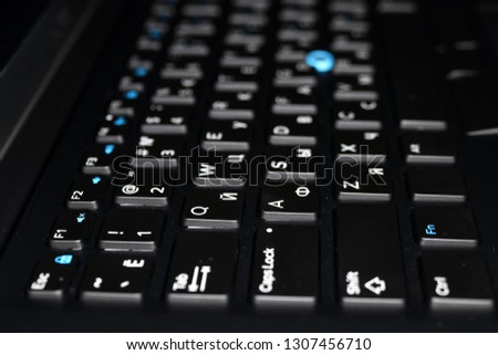 Modern laptop keyboard with a pointing stick Royalty-Free Stock Photo #1307456710