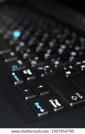 Modern laptop keyboard with a pointing stick Royalty-Free Stock Photo #1307456740