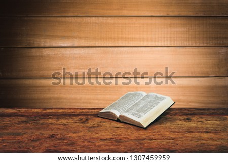 Bible on a old wooden table background.