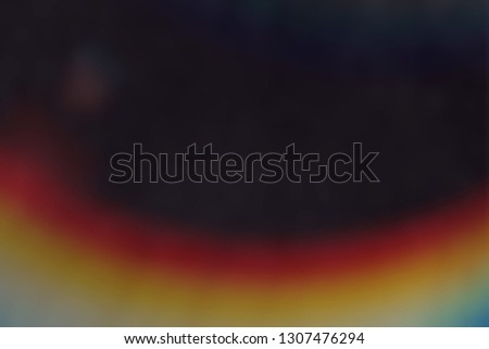 Blank grained and scratched film strip texture background with heavy grain, dust and a light leak Real Lens Flare Shot in Studio over Black Background. Easy to add as Overlay or Screen Filter  Royalty-Free Stock Photo #1307476294