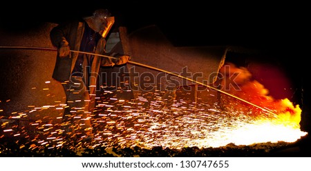 Steelmaker Burns Oxygen Opening for Producing of Cast-!ron from a High Furnace. Iron and Steel Metallurgical Plant. Metallurgic production, production of cast iron, metal melting.