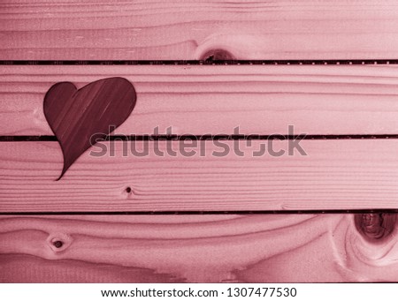 Valentine's day, red heart of paper resting on beech wood slats, monochrome interpretation of the shot with soft red lights.