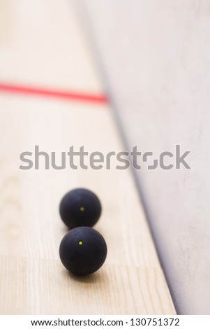 Two squash balls with yellow dots