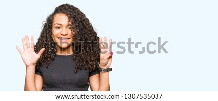 Young beautiful woman with curly hair showing and pointing up with fingers number eight while smiling confident and happy.