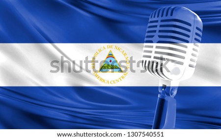 Microphone on fabric background of flag of Nicaragua close-up