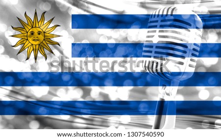 Microphone on a background of a blurry Uruguay flag close-up