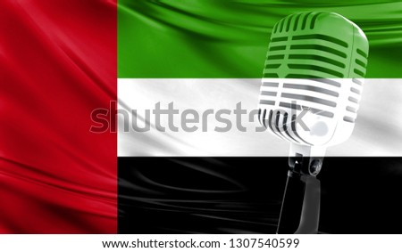 Microphone on fabric background of flag of United Arab Emirates close-up