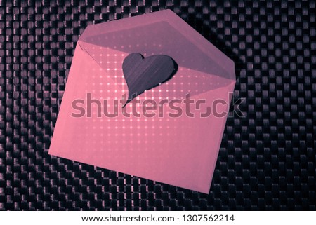 Concept: Heart Mail. Heart of paper resting on a white letter, texture of the checkered background, interpretation of the monochromatic shot.