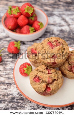 Homemade vegan gluten free muffins with fresh strawberries, selective focus