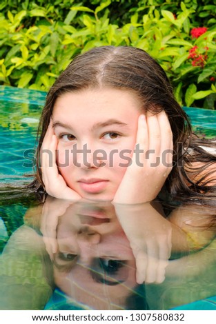 Teen girl long-haired brunette in the swimming pool