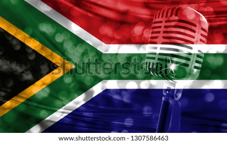Microphone on a background of a blurry South Africa flag close-up