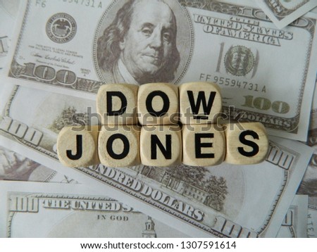 Dow jones spelled out using game blocks on an American currency background Royalty-Free Stock Photo #1307591614