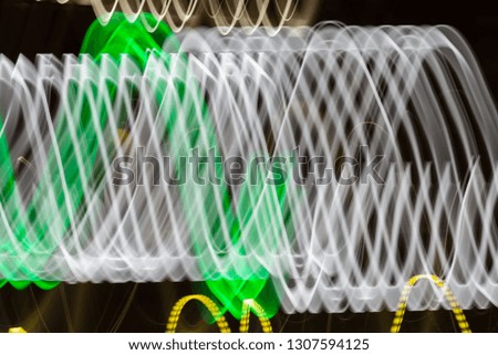 Abstract blurred colorful light effect on a black background. Long exposure photo of moving camera.