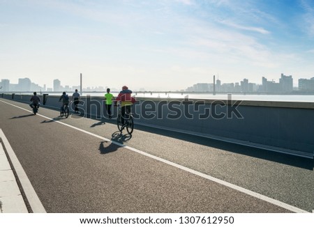 Bicycle riders on Riverside Highway, Hangzhou, China