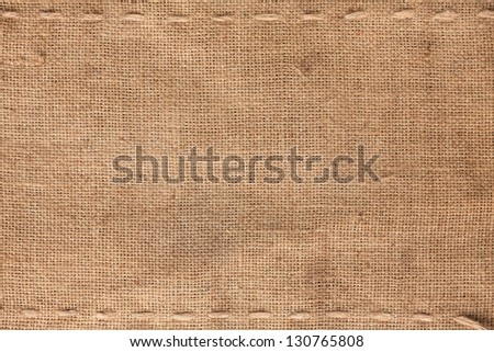 The two horizontal stitching on the burlap as background Royalty-Free Stock Photo #130765808