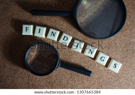 Finding issue conceptual photo using magnifying glass. It involves selective focus, light, shadows and wooden background.