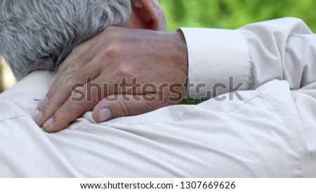 Man massaging numb neck, problems with spine, bad sleep conditions, healthcare