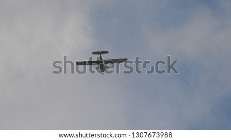 Zoom photo of single engine small airplane flying in the sky