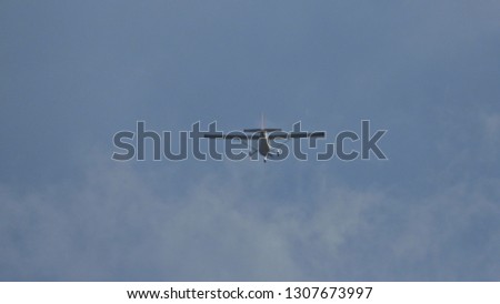 Zoom photo of single engine small airplane flying in the sky