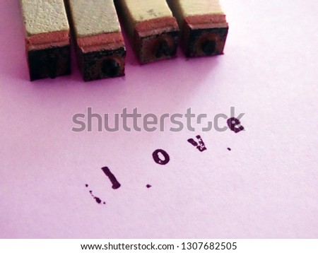 Love Text Stamp on a Pink Paper Sheet