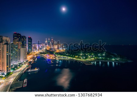 Busan beach view city in night time with blue sky and full moon, South Korea, this picture can use for tavel, Busa, South Korea and  city concept
