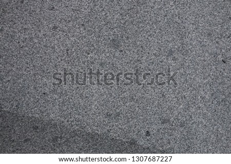 Gray granite texture. Subtle grain stone background. Dark rough granitic wall