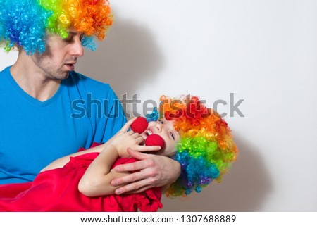 Birthday. A clown and a child in a red dress on the background of bright confetti celebrates a bright event. Have fun-image