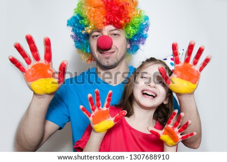 Birthday. A clown and a child in a red dress on the background of bright confetti celebrates a bright event. Have fun-image