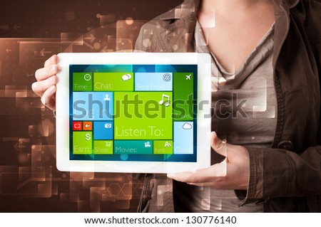 Young lady holding tablet with modern software operational system