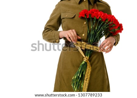 Portrait of a young woman with red carnations in her hands, celebrating the 76th anniversary of victory in world war II. may 1, may 9. Moscow, Russia. Translation of the inscription: "eternal memory"